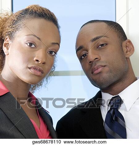 Stock Image - Portrait of a businessman and a businesswoman. Fotosearch