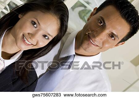 Portrait of a businessman and a businesswoman smiling View Large Photo Image Stock Image - Portrait of a businessman and a businesswoman smiling. Fotosearch