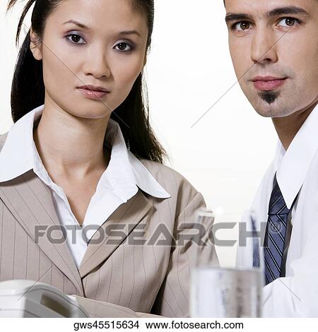 Portrait of a businessman sitting with a businesswoman View Large Photo Image Picture - Portrait of a businessman sitting with a businesswoman. Fotosearch