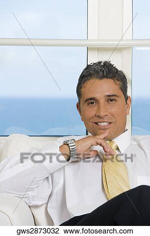 Portrait of a businessman smiling View Large Photo Image Stock Image - Portrait of a businessman smiling. Fotosearch
