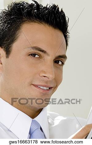 Portrait of a businessman smiling View Large Photo Image Stock Photo - Portrait of a businessman smiling. Fotosearch
