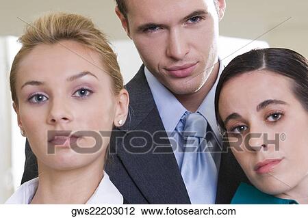 Portrait of a businessman standing with two businesswomen View Large Photo Image Stock Image - Portrait of a businessman standing with two businesswomen. Fotosearch