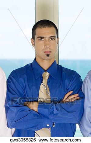 Portrait of a businessman standing with his arms crossed View Large Photo Image Stock Photograph - Portrait of a businessman standing with his arms crossed. Fotosearch