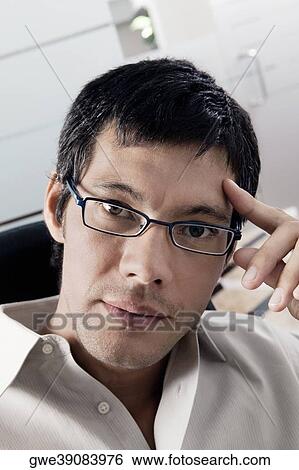 Portrait of a businessman thinking View Large Photo Image Stock Photograph - Portrait of a businessman thinking. Fotosearch