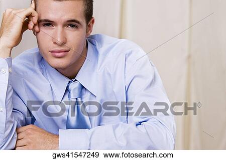 Portrait of a businessman with his hand on his temple View Large Photo Image Stock Photo - Portrait of a businessman with his hand on his temple. Fotosearch