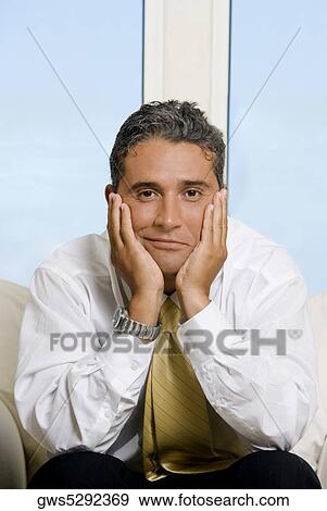 Portrait of a businessman with his hands on his cheeks View Large Photo Image Stock Photo - Portrait of a businessman with his hands on his cheeks. Fotosearch