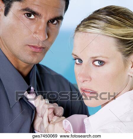 Portrait of a businesswoman adjusting a businessman's tie View Large Photo Image Stock Photo - Portrait of a businesswoman adjusting a businessman's tie. Fotosearch