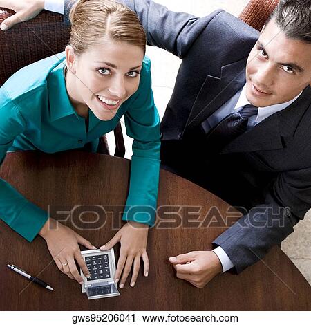 Portrait of a businesswoman and a businessman smiling View Large Photo Image Stock Image - Portrait of a businesswoman and a businessman smiling. Fotosearch