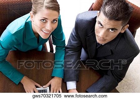 Stock Photography - Portrait of a businesswoman and a businessman smiling. Fotosearch
