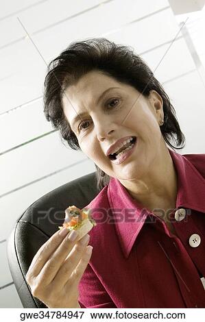 Portrait of a businesswoman having meal View Large Photo Image Stock Photo - Portrait of a businesswoman having meal. Fotosearch