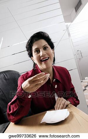 Portrait of a businesswoman having dessert View Large Photo Image Stock Photograph - Portrait of a businesswoman having dessert. Fotosearch