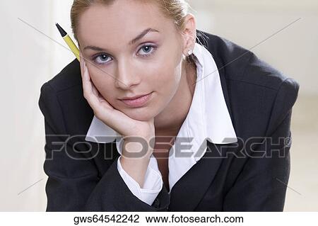 Stock Image - Portrait of a businesswoman holding a pen. Fotosearch