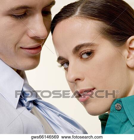 Stock Photo - Portrait of a businesswoman holding a businessman by his tie. Fotosearch