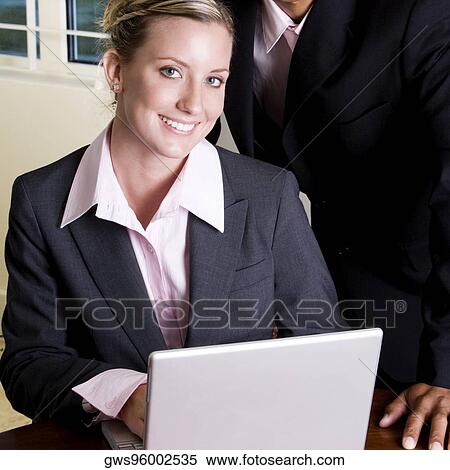 Portrait of a businesswoman in front of a laptop View Large Photo Image Stock Photography - Portrait of a businesswoman in front of a laptop. Fotosearch
