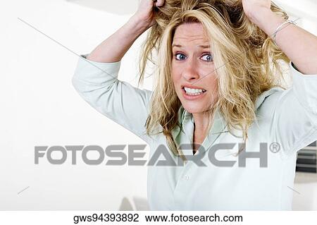 Portrait of a businesswoman pulling her hair View Large Photo Image Stock Image - Portrait of a businesswoman pulling her hair. Fotosearch