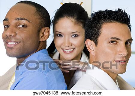 Portrait of a businesswoman resting her hands on the shoulders of two businessmen View Large Photo Image Stock Photo - Portrait of a businesswoman resting her hands on the shoulders of two businessmen. Fotosearch