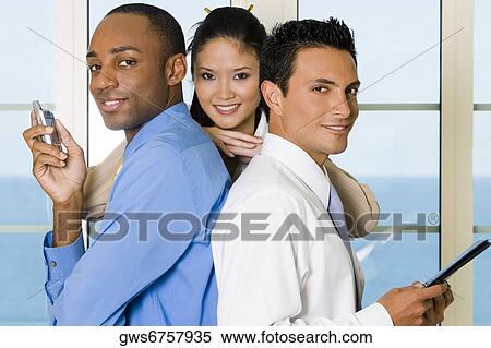 Portrait of a businesswoman resting her hands on the shoulders of two businessmen View Large Photo Image Stock Photography - Portrait of a businesswoman resting her hands on the shoulders of two businessmen. Fotosearch