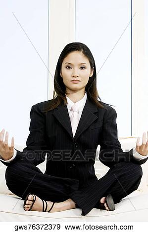 Portrait of a businesswoman sitting in the lotus position View Large Photo Image Stock Photo - Portrait of a businesswoman sitting in the lotus position. Fotosearch