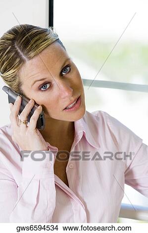 Portrait of a businesswoman talking on a mobile phone View Large Photo Image Picture - Portrait of a businesswoman talking on a mobile phone. Fotosearch
