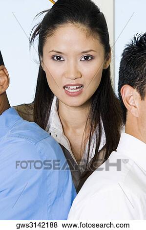 Portrait of a businesswoman with two businessmen View Large Photo Image Stock Photo - Portrait of a businesswoman with two businessmen. Fotosearch