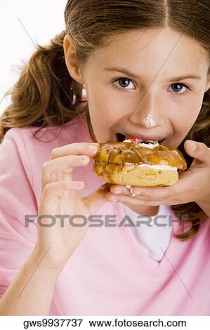 Portrait of a girl eating dessert View Large Photo Image Stock Photo - Portrait of a girl eating dessert. Fotosearch