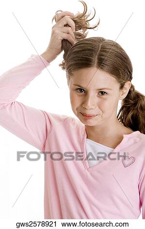 Portrait of a girl holding her pigtails View Large Photo Image Stock Image - Portrait of a girl holding her pigtails. Fotosearch