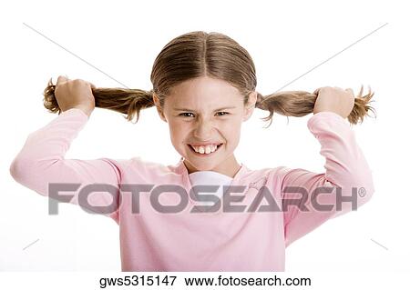Portrait of a girl holding her pigtails View Large Photo Image Stock Photo - Portrait of a girl holding her pigtails. Fotosearch