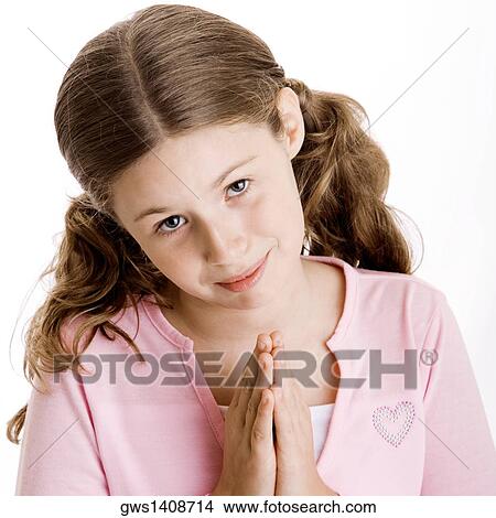 Portrait of a girl in a prayer position View Large Photo Image Picture - Portrait of a girl in a prayer position. Fotosearch