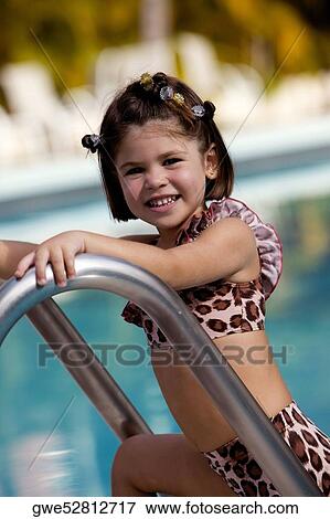 Portrait of a girl smiling by the pool View Large Photo Image Stock Photo - Portrait of a girl smiling by the pool. Fotosearch