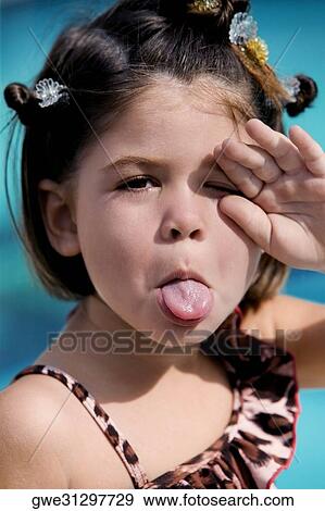 Portrait of a girl sticking her tongue out View Large Photo Image Stock Photo - Portrait of a girl sticking her tongue out. Fotosearch