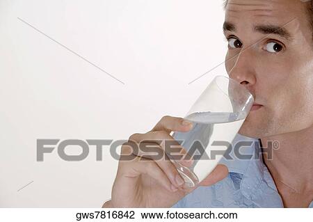 Portrait of a mid adult man drinking a glass of water View Large Photo Image Stock Image - Portrait of a mid adult man drinking a glass of water. Fotosearch
