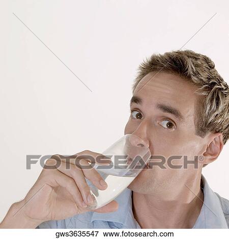 Stock Photo - Portrait of a mid adult man drinking a glass of water. Fotosearch