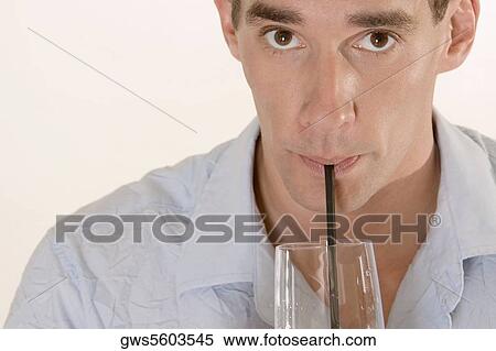 Portrait of a mid adult man drinking with a straw View Large Photo Image Stock Photography - Portrait of a mid adult man drinking with a straw. Fotosearch