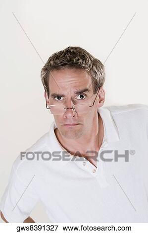 Stock Photo - Portrait of a mid adult man frowning. Fotosearch