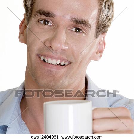 Portrait of a mid adult man holding a cup View Large Photo Image Stock Image - Portrait of a mid adult man holding a cup. Fotosearch