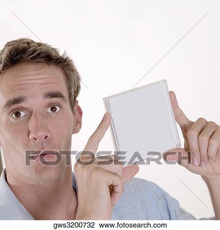 Portrait of a mid adult man holding a CD case View Large Photo Image Stock Image - Portrait of a mid adult man holding a CD case. Fotosearch