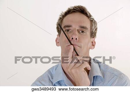 Portrait of a mid adult man holding a drinking straw close to his mouth View Large Photo Image Stock Image - Portrait of a mid adult man holding a drinking straw close to his mouth. Fotosearch