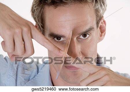 Portrait of a mid adult man holding a CD in front of his face View Large Photo Image Stock Image - Portrait of a mid adult man holding a CD in front of his face. Fotosearch