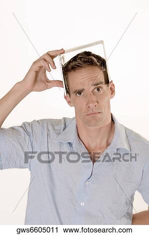 Portrait of a mid adult man holding a CD case on his head View Large Photo Image Stock Image - Portrait of a mid adult man holding a CD case on his head. Fotosearch