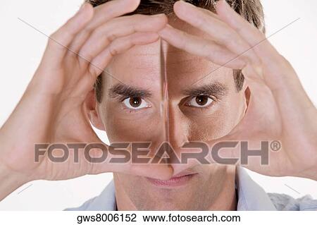 Portrait of a mid adult man holding a CD in front of his face View Large Photo Image Stock Image - Portrait of a mid adult man holding a CD in front of his face. Fotosearch