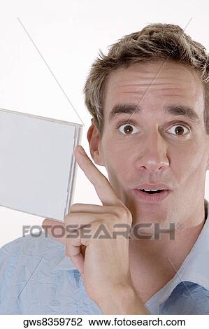 Portrait of a mid adult man holding a CD case View Large Photo Image Stock Image - Portrait of a mid adult man holding a CD case. Fotosearch