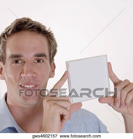 Portrait of a mid adult man holding a CD case View Large Photo Image Stock Photo - Portrait of a mid adult man holding a CD case. Fotosearch