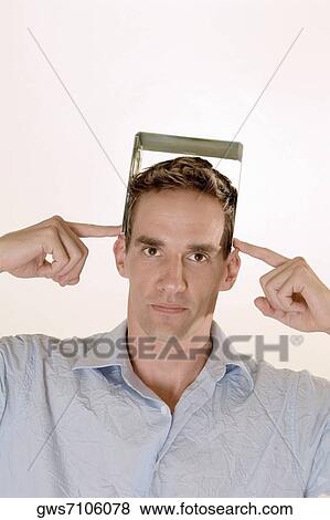 Portrait of a mid adult man holding a CD case on his head View Large Photo Image Stock Photo - Portrait of a mid adult man holding a CD case on his head. Fotosearch