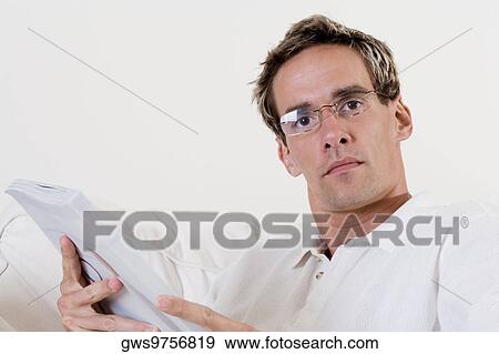Portrait of a mid adult man holding a book View Large Photo Image Stock Photo - Portrait of a mid adult man holding a book. Fotosearch
