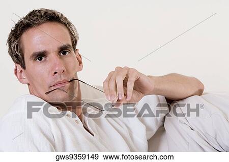 Portrait of a mid adult man holding his eyeglasses View Large Photo Image Stock Photo - Portrait of a mid adult man holding his eyeglasses. Fotosearch