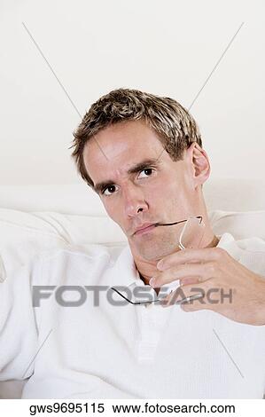 Portrait of a mid adult man holding his eyeglasses View Large Photo Image Stock Photography - Portrait of a mid adult man holding his eyeglasses. Fotosearch