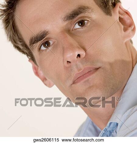 Stock Photography - Portrait of a mid adult man looking serious. Fotosearch