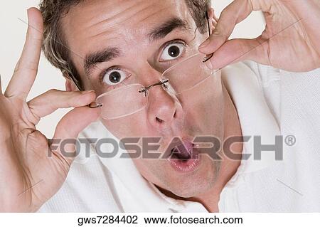 Stock Image - Portrait of a mid adult man making a face. Fotosearch