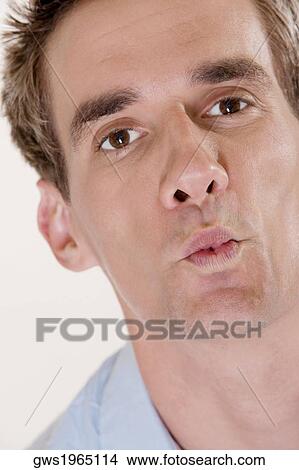 Portrait of a mid adult man puckering his lips View Large Photo Image Picture - Portrait of a mid adult man puckering his lips. Fotosearch