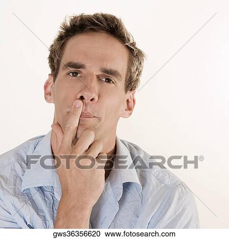 Stock Image - Portrait of a mid adult man thinking. Fotosearch